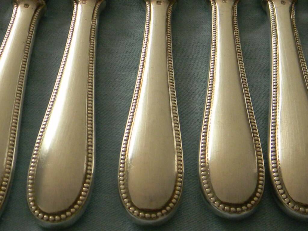 Set of 12 cheese or fruit knives with silver metal handles.
