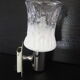 Transparent and white glass torch-type wall light.