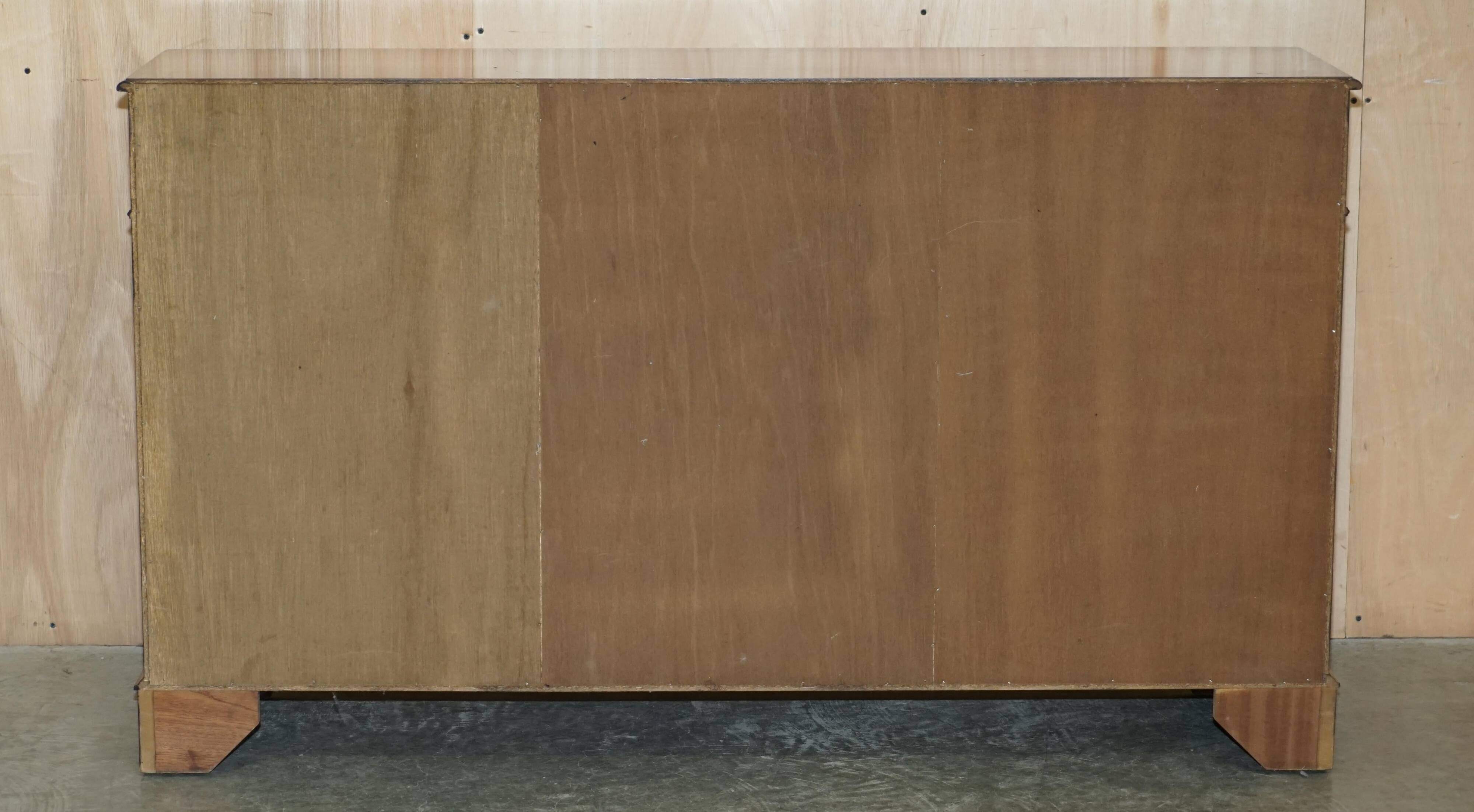 Vintage mahogany buffet with three drawers and shelves.