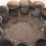 Ceramic liquor service with a decanter and 12 small glasses on tray