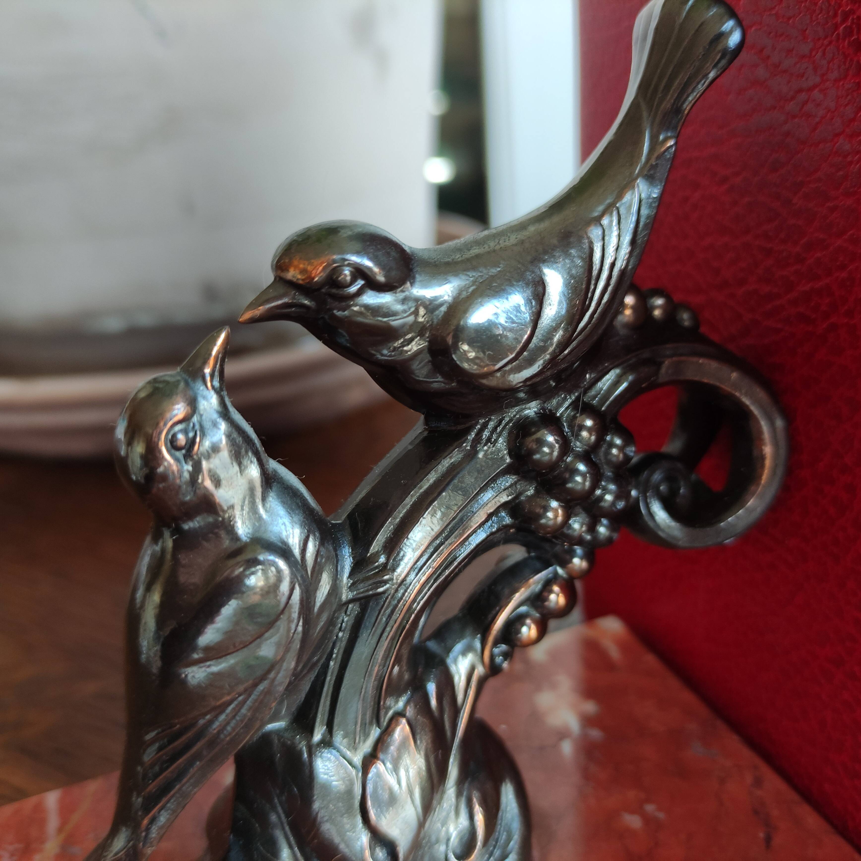 Zinc art bookends in the shape of birds on red marble - warblers