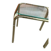 Vintage 1970s coffee table in gilded brass with a transparent glass top — straw yellow.
