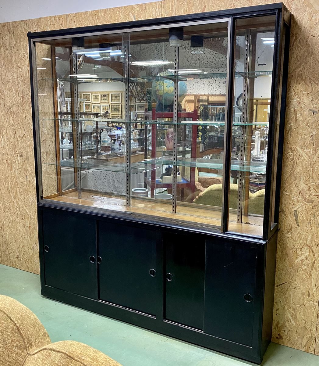 Store window with sliding doors in matte black patinated oak - 30s
