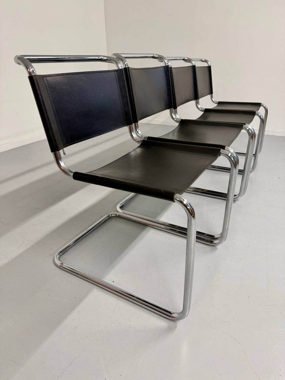 Lot of 4 tubular chairs designed by Mart Stam in vintage black leather from the 1980s.