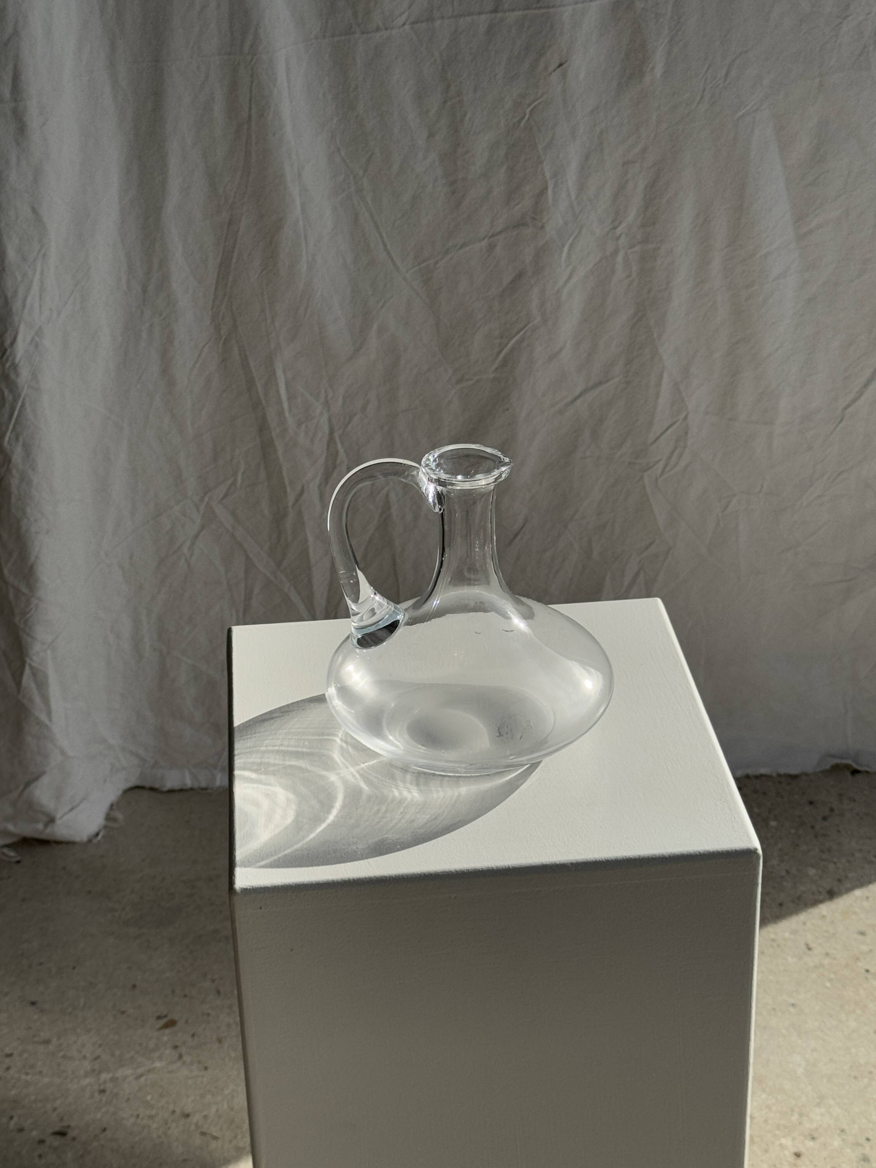 Vintage glass carafe with flattened flared belly handle H18