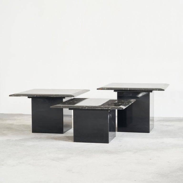 Set of 3 marble and lacquer coffee tables, 1970s.