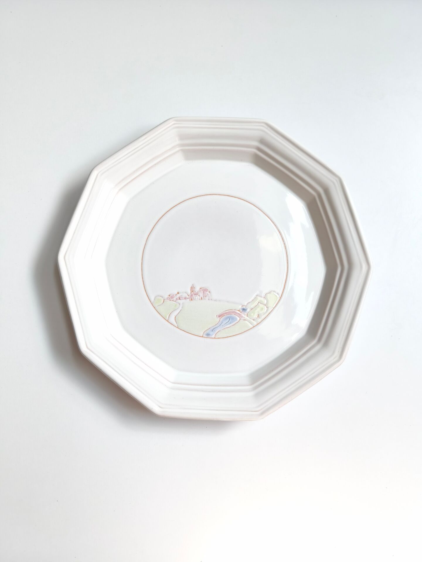 Round vintage Niderviller plate with a country decor.