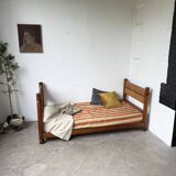 Brutalist style bed with chain and straw
