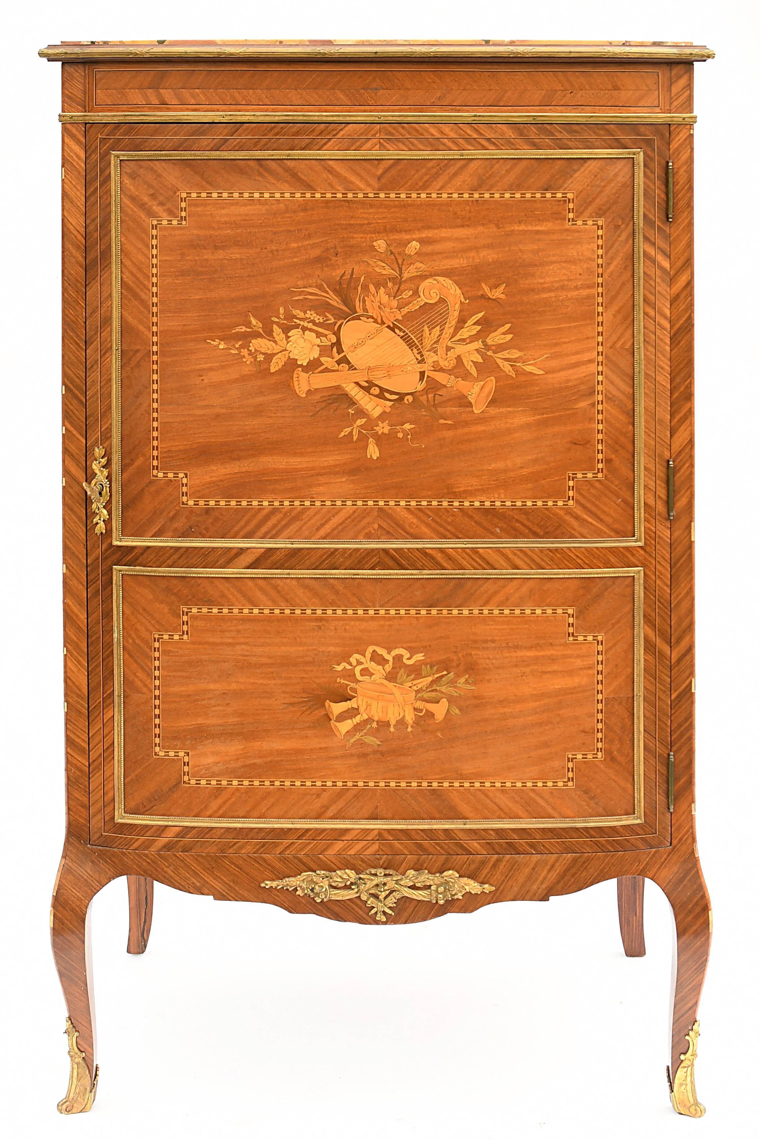In-between furniture in marquetry decorated with a trophy decoration of musical instruments