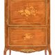 In-between furniture in marquetry decorated with a trophy decoration of musical instruments