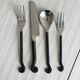 Set of 4 hammered metal cutlery with snail pattern.