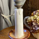 Candle holder-style lamp made entirely of ceramic.