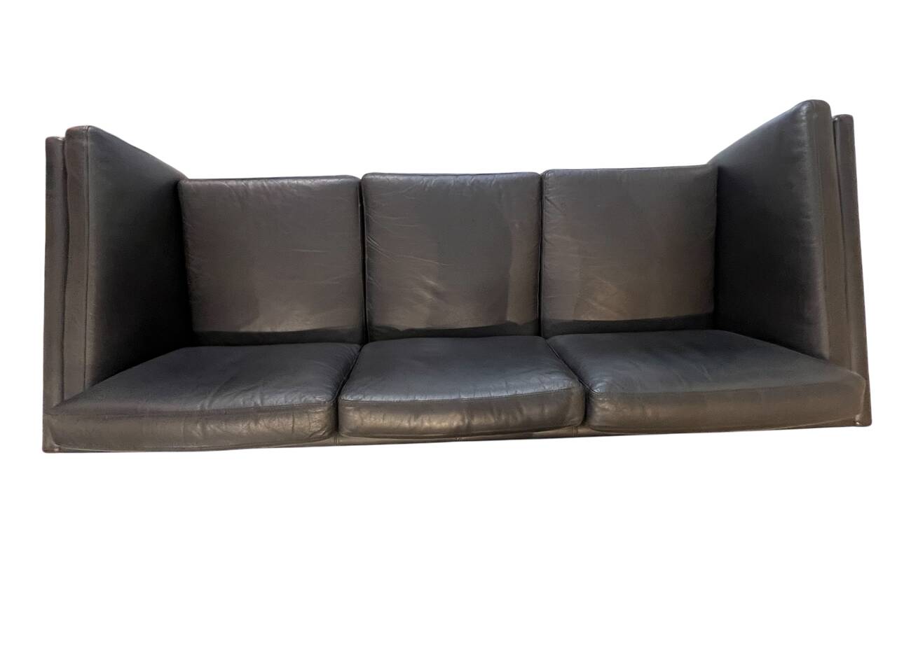 Black leather three-seater sofa