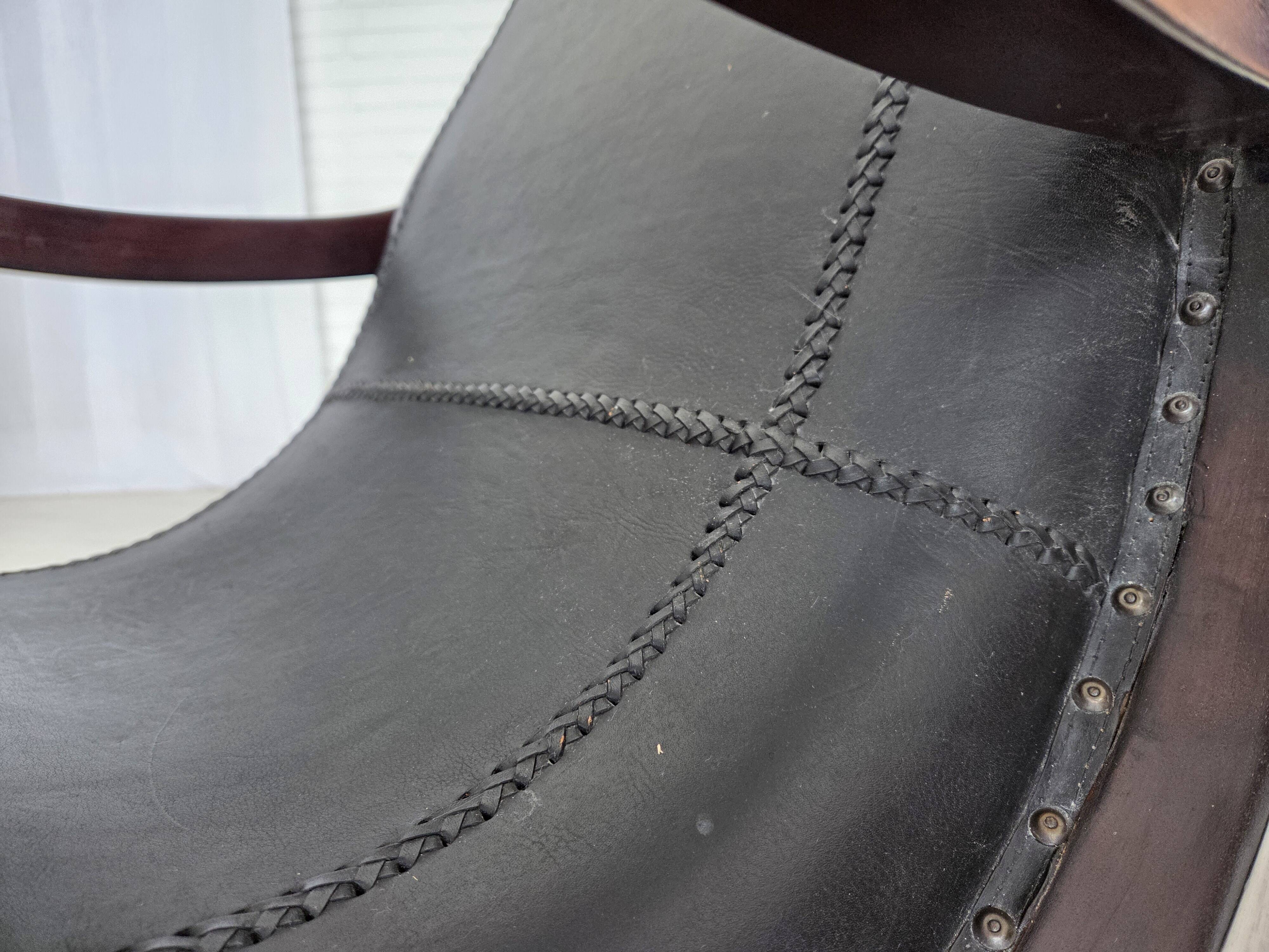 1970s, vintage armchair with footstool, black furniture leather.