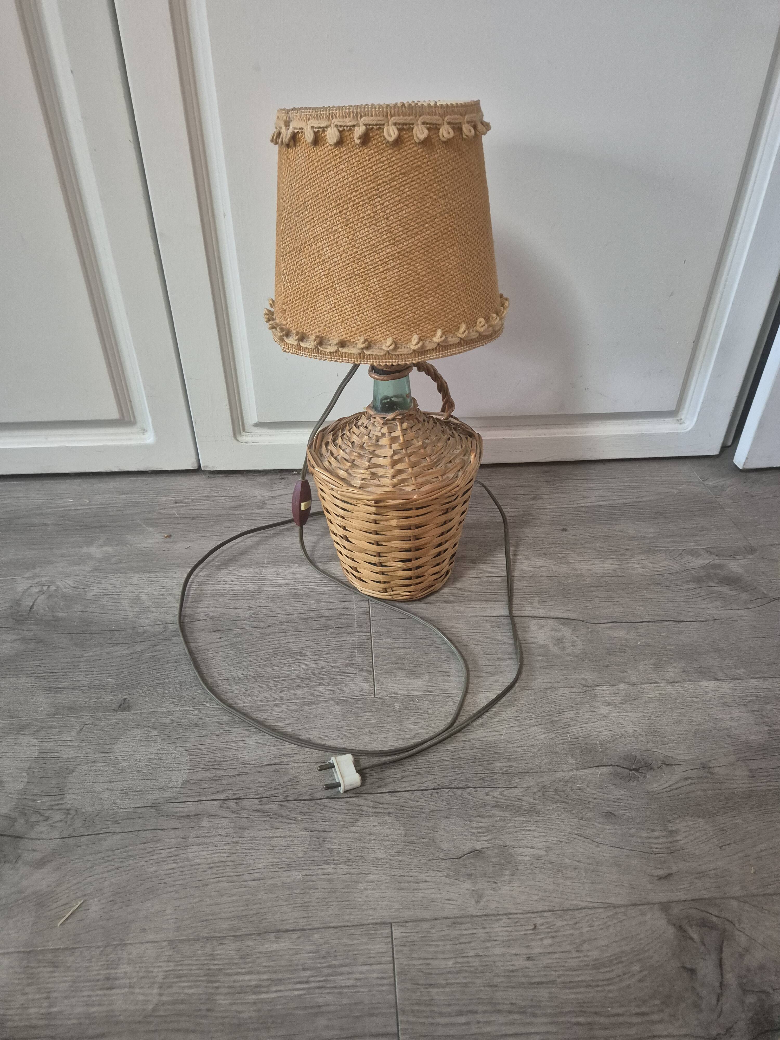 vintage table lamp dame jeanne covered in rattan wicker with a handle