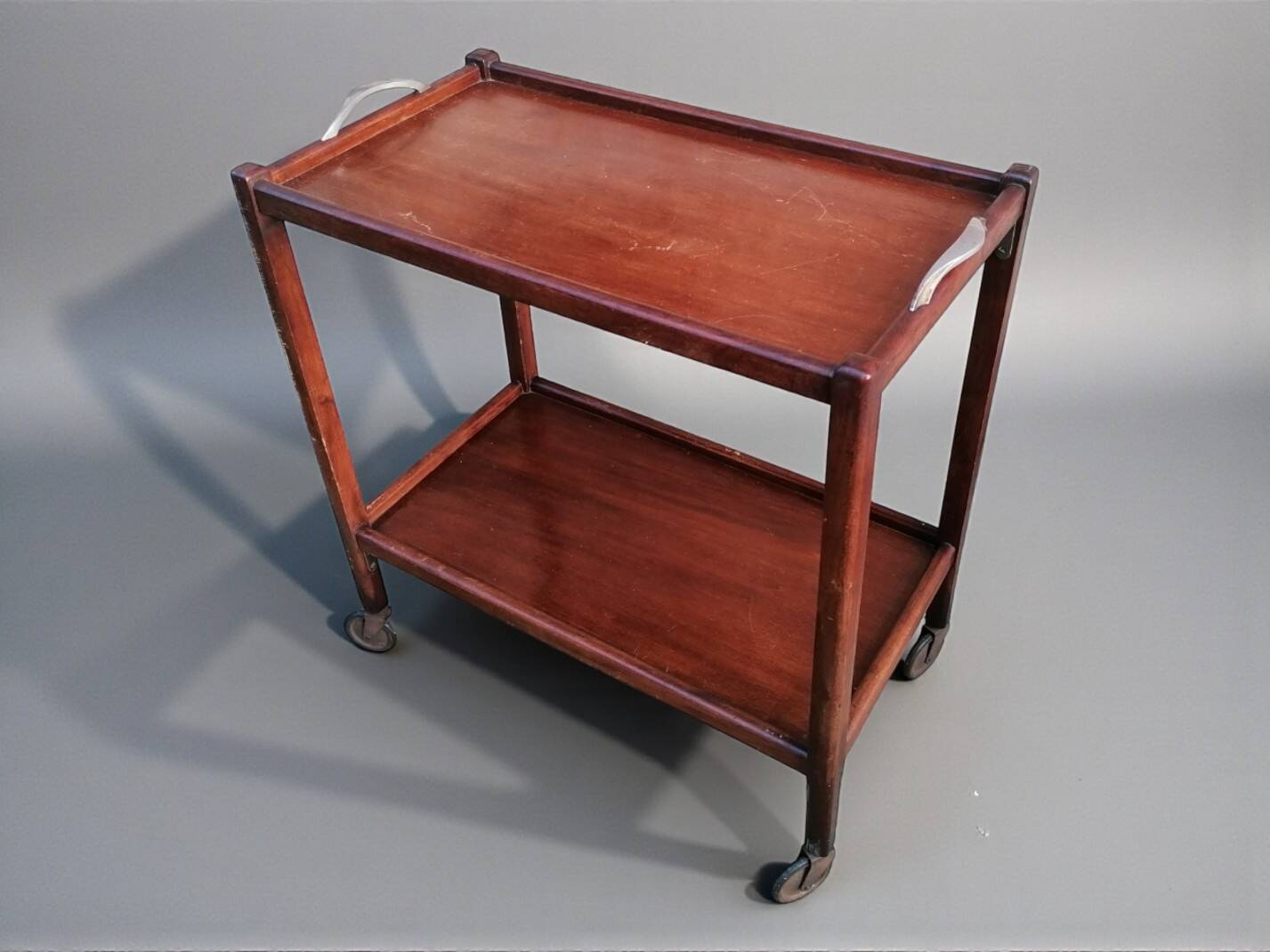 Art Deco wooden serving trolley on wheels.