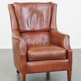 Cowhide armchair in good condition, finished with decorative nails