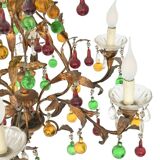 Lustrous chandelier with two wall lights decorated with foliage and pendants.