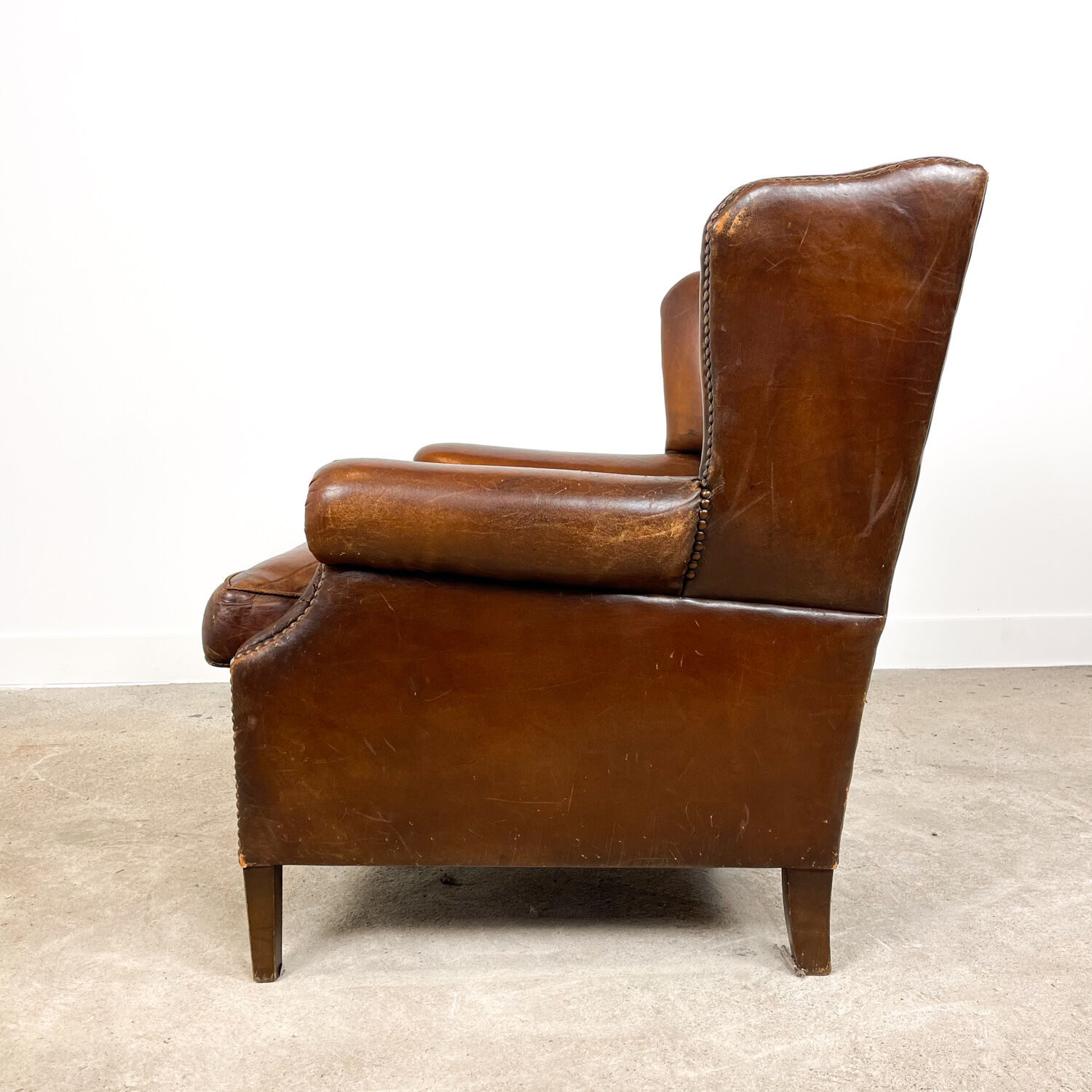 Dark brown sheep leather wingback armchair vintage