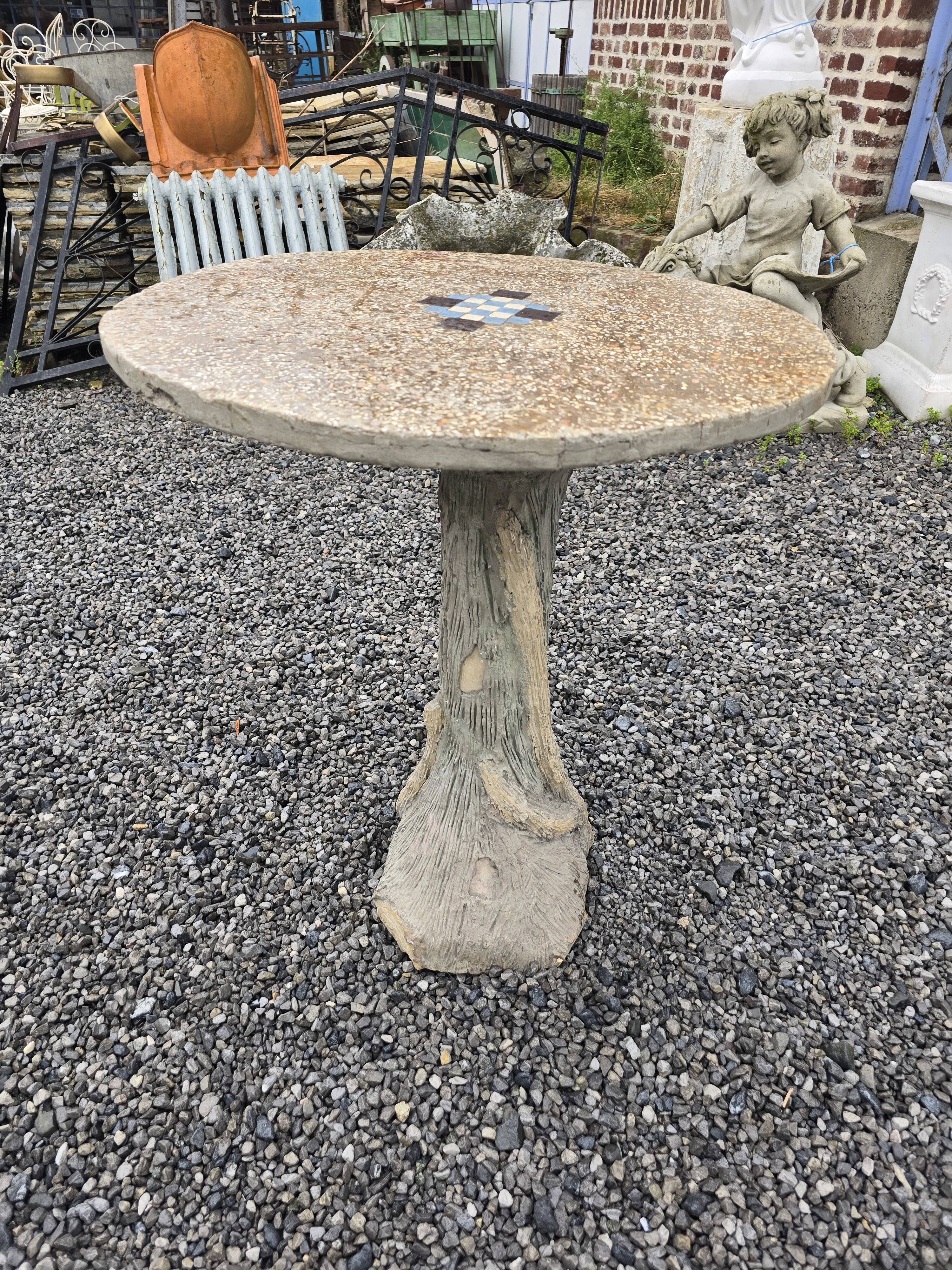Cement garden table with trunk-shaped foot