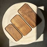 Trio of rounded rectangular trays or cups in monoxyl teak L:35