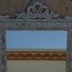 Chic and stylish old mirror with carved wooden frame in limed white and gold