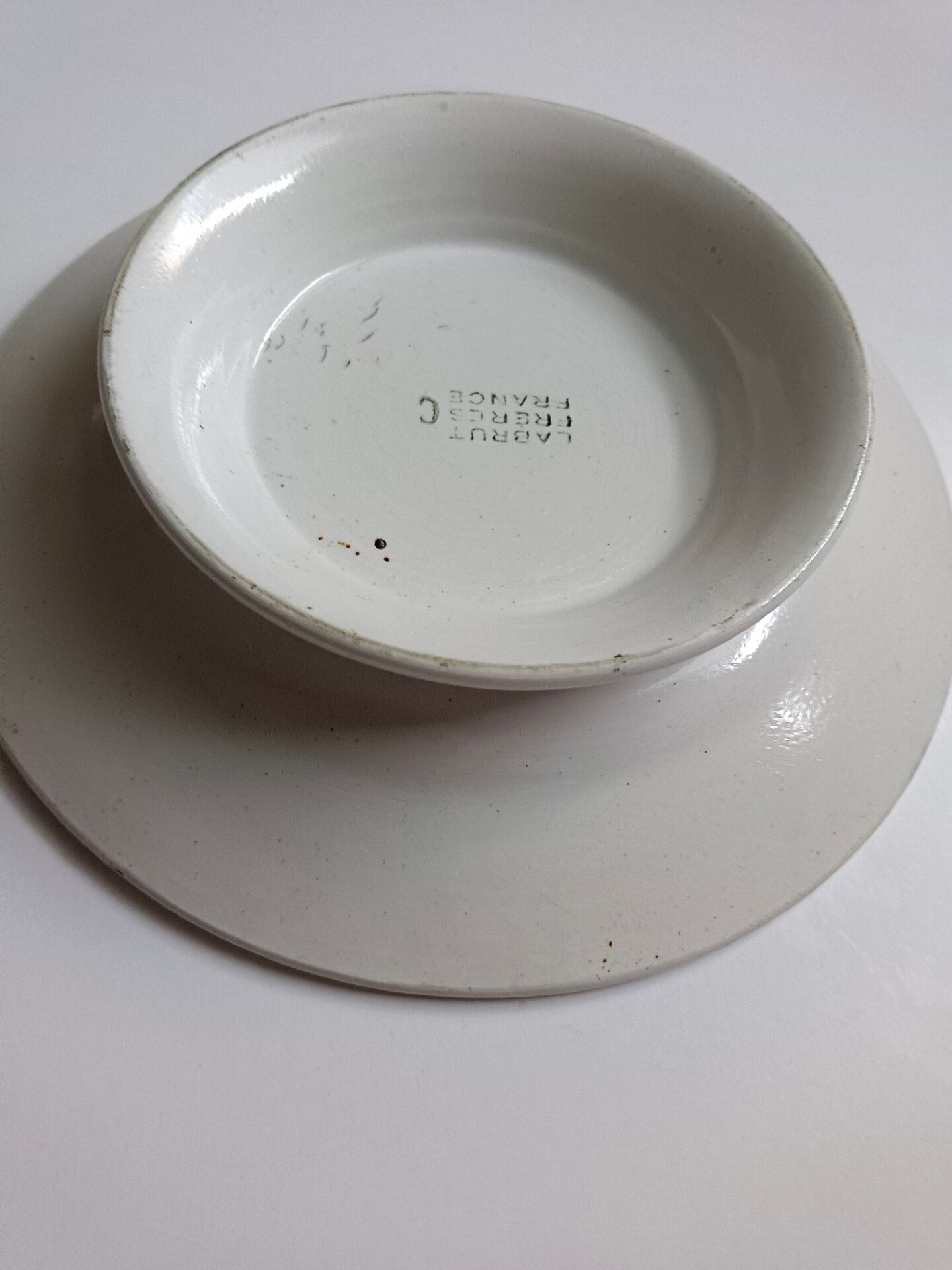 Old round footed plate signed Labrut brothers flowers