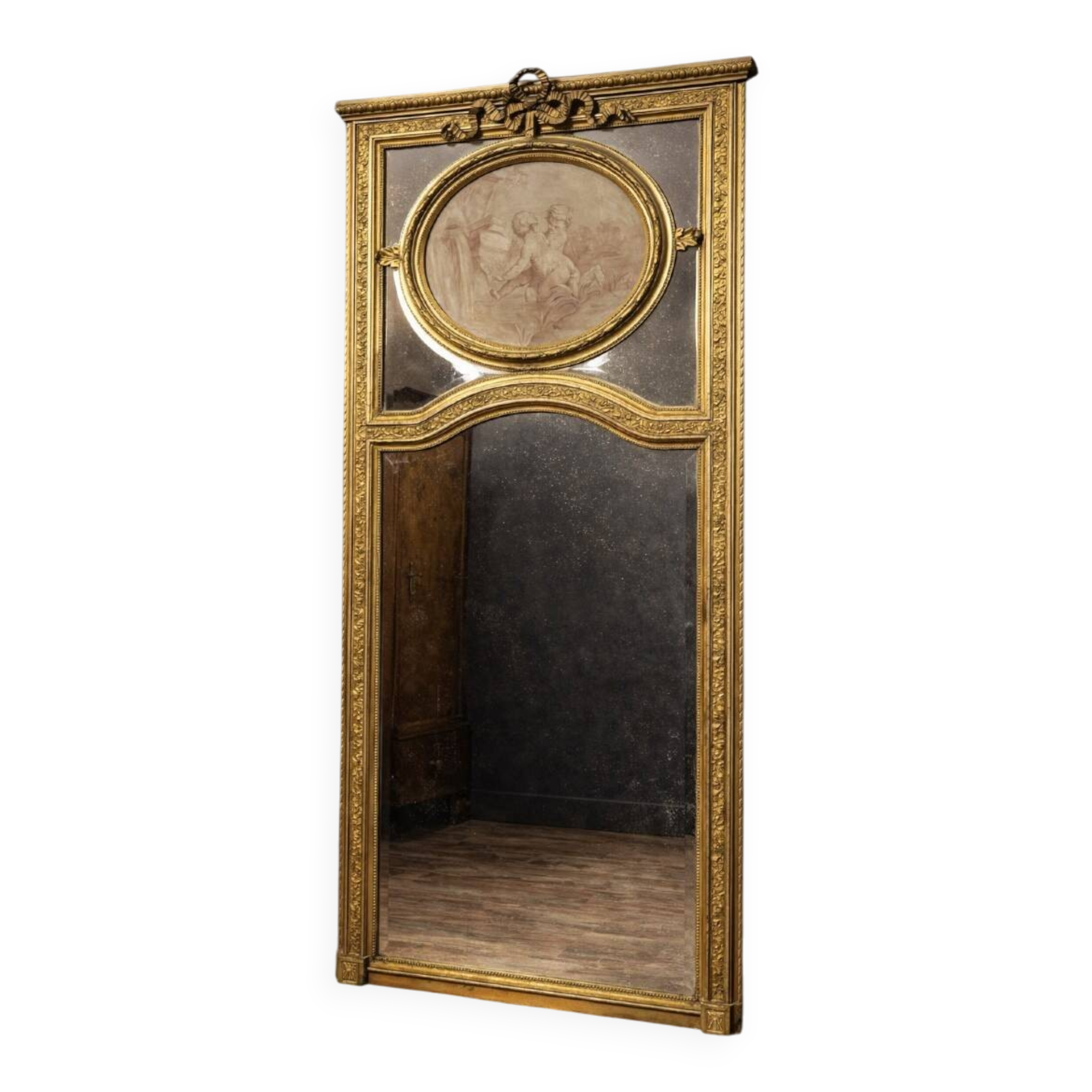 Very large mirror with mouldings, richly carved and gilded, in the Louis XVI style.