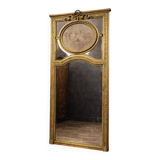 Very large mirror with mouldings, richly carved and gilded, in the Louis XVI style.