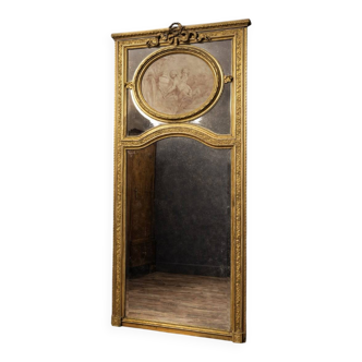 Very large mirror with mouldings, richly carved and gilded, in the Louis XVI style.