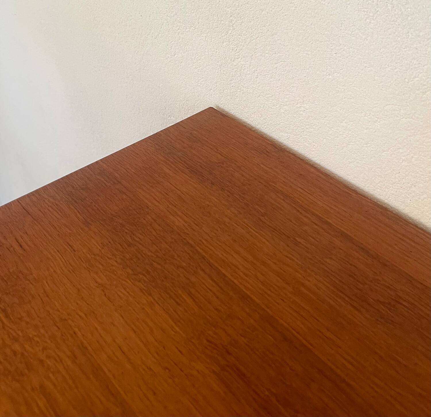 Vintage 1960s chest of drawers with covered handles.