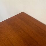 Vintage 1960s chest of drawers with covered handles.