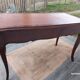 Louis XV style desk in wood, with a brown leather top.
