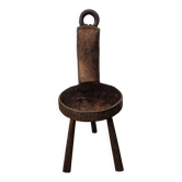 Antique tripod chair in solid wood and animal skin.
