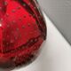 Small glass bowl in beautiful emerald red color with inlaid bubbles.