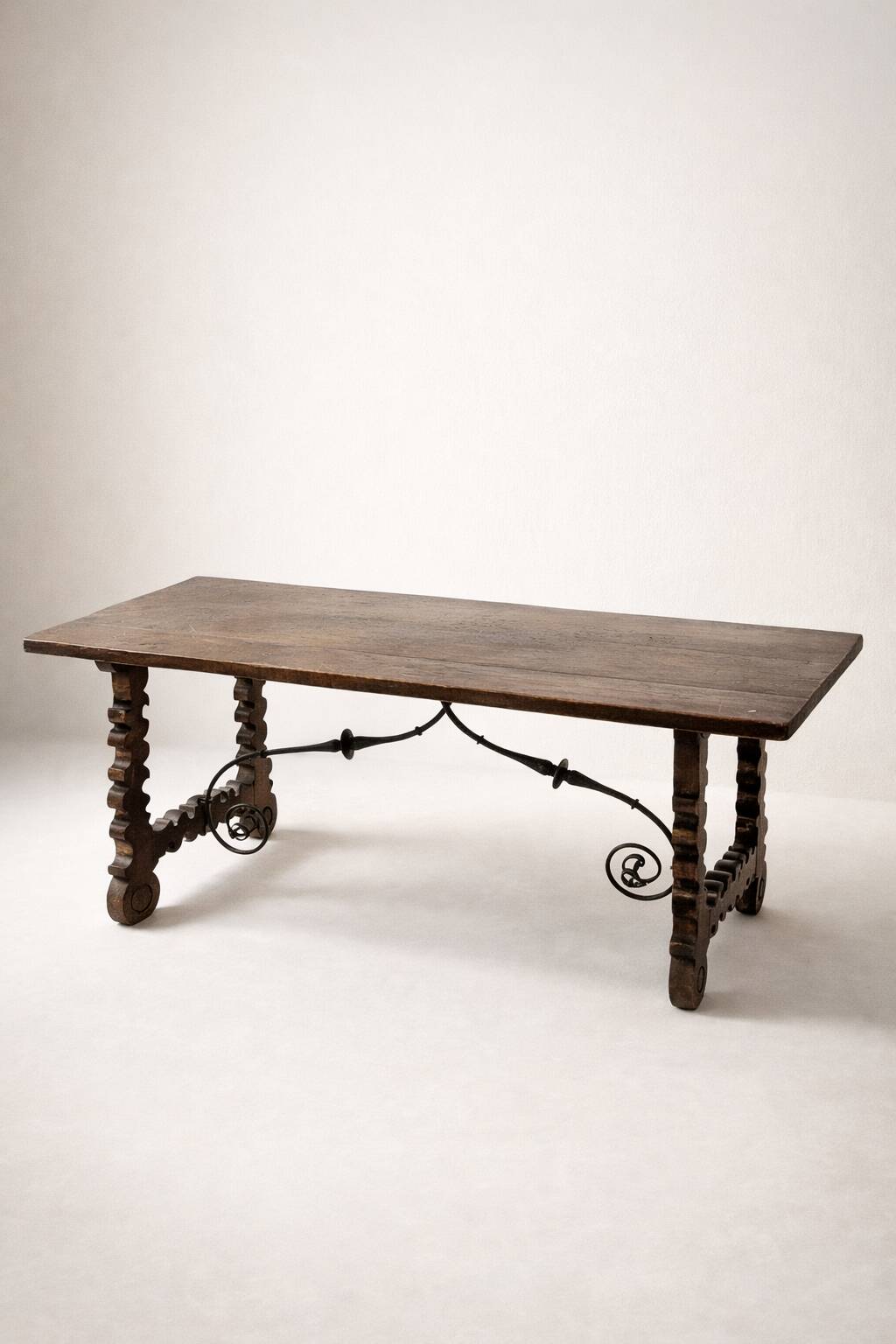 Spanish table in walnut and wrought iron, lyre-shaped base.