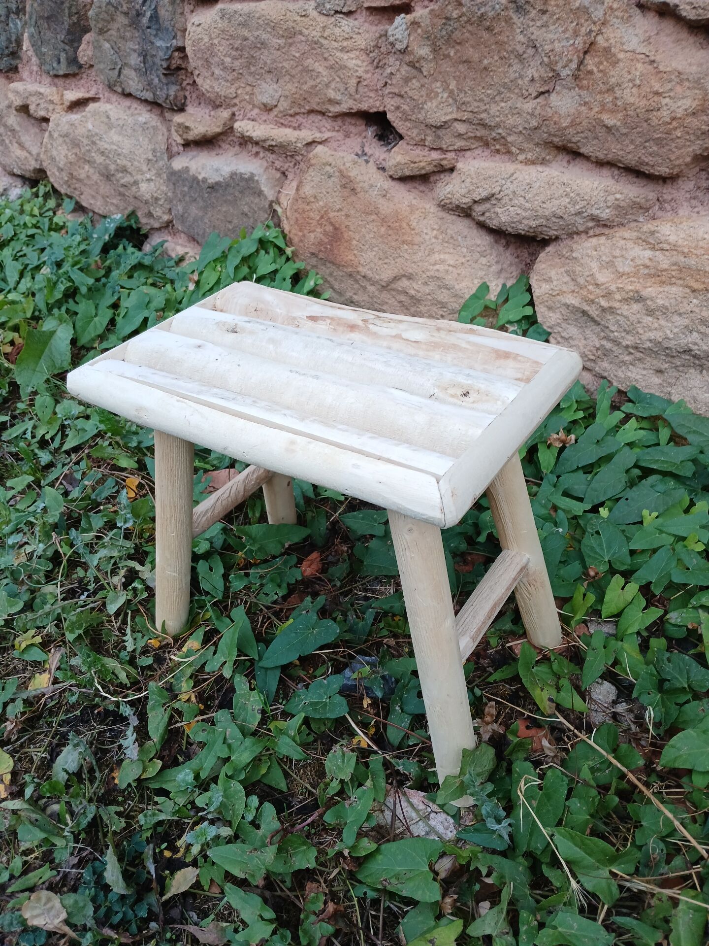 Small stool in raw wood