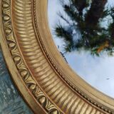 Antique oval mirror in gilded stucco with gold leaf, 19th century