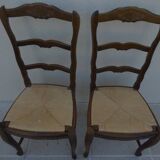 2 stylish solid wood chairs with high backs and straw seats