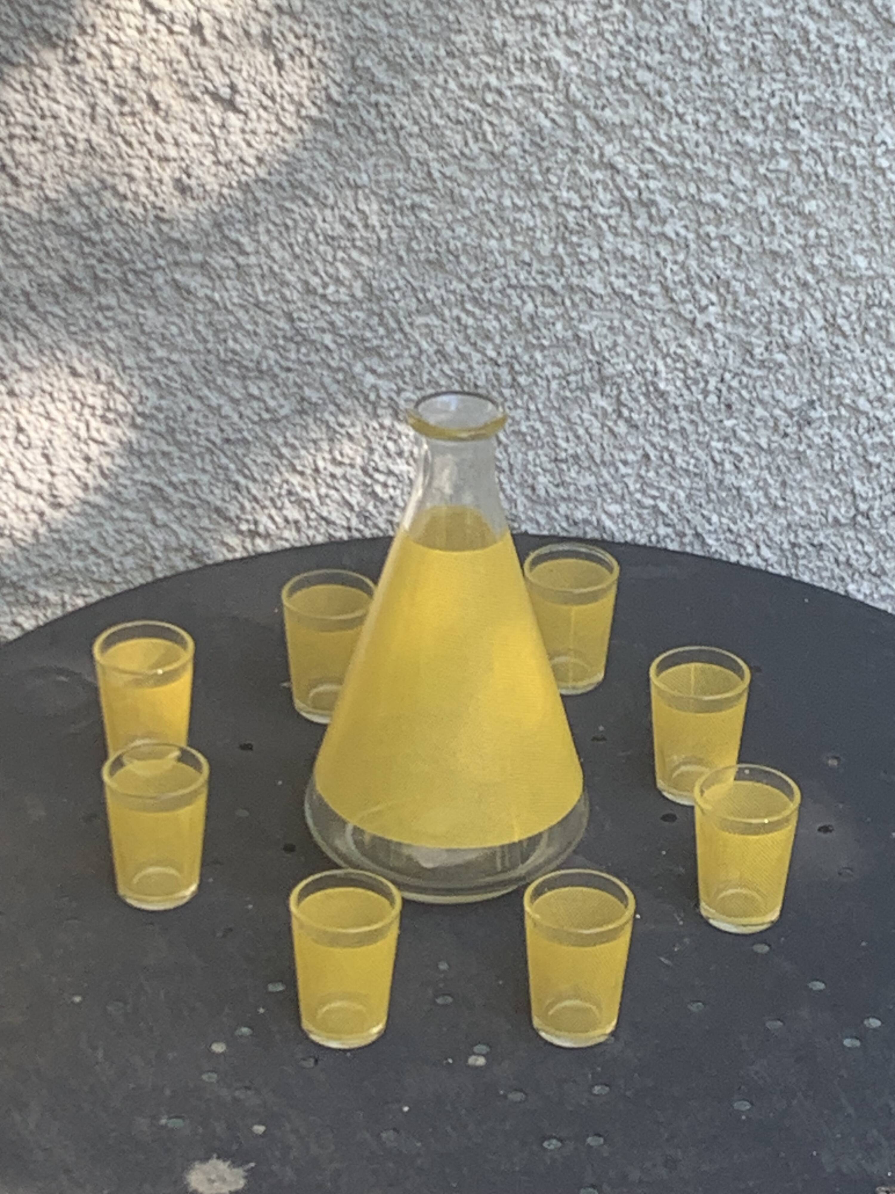 Liqueur set consisting of a glass carafe and 8 small yellow glasses