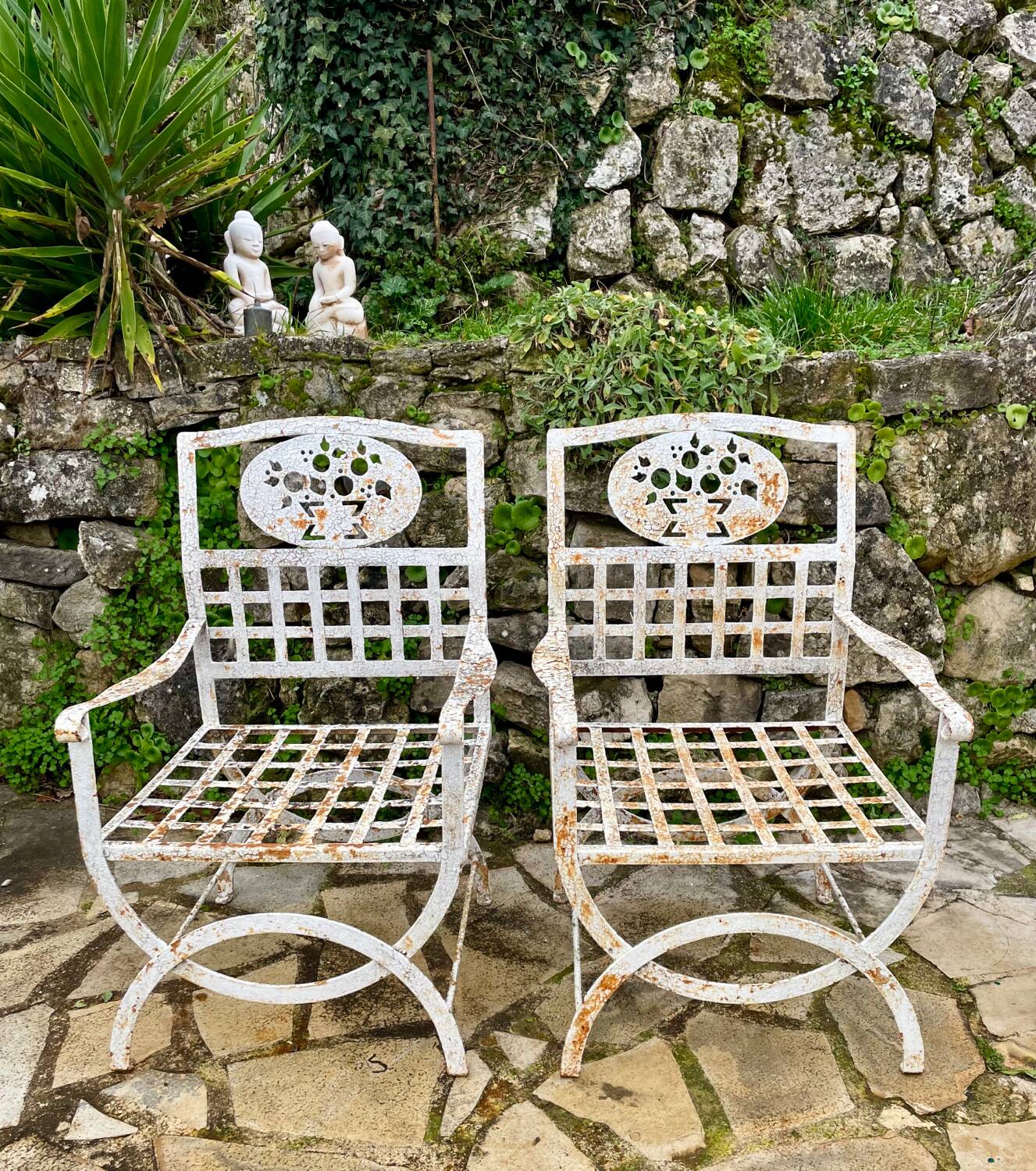 Pair of wrought iron armchairs