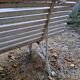Pair of antique wooden slatted benches with wrought iron legs.