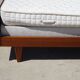 Vintage bed in teak with integrated bedside table.