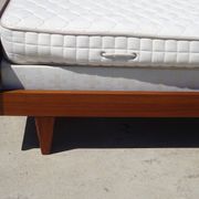 Vintage bed in teak with integrated bedside table.
