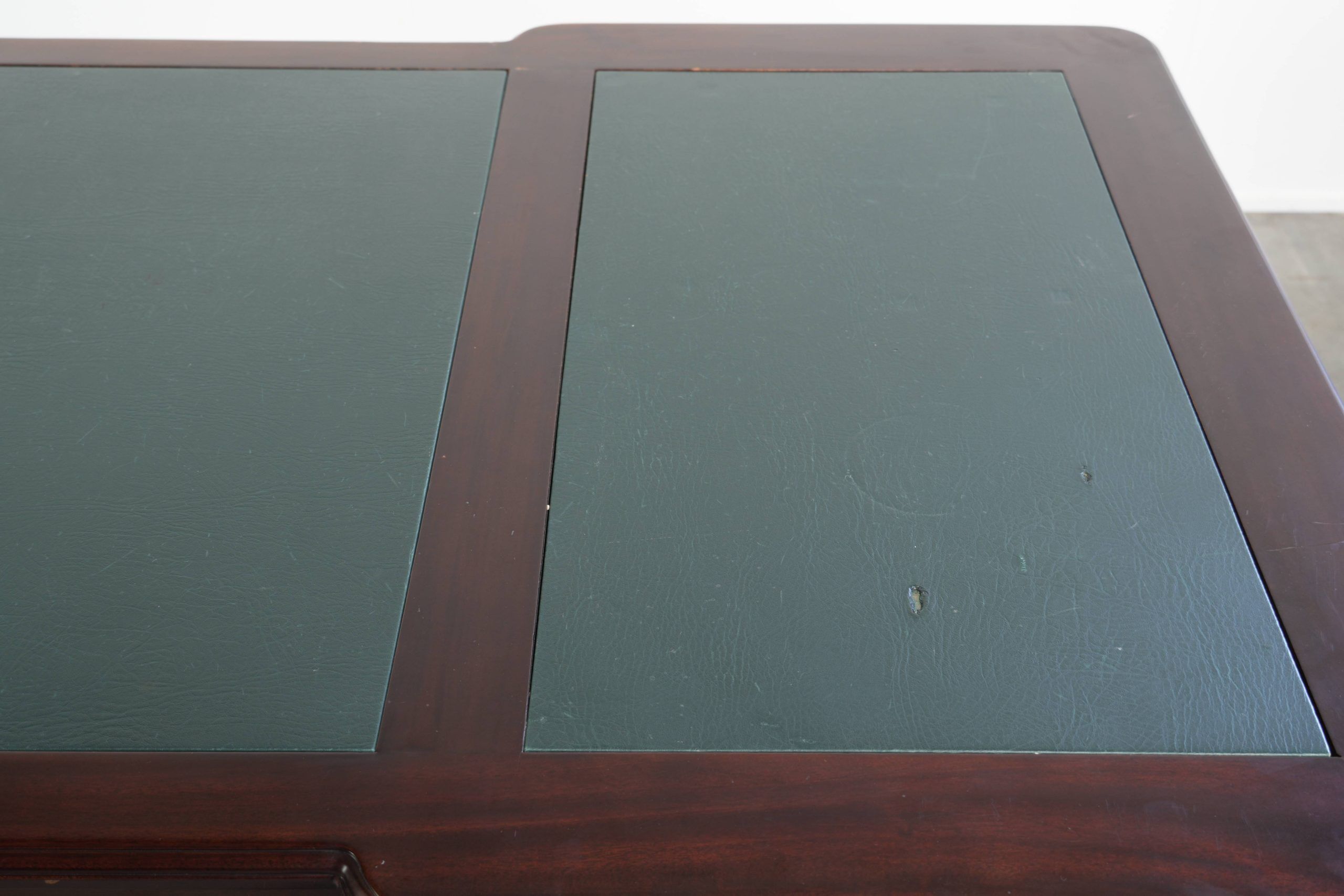 Partner desk in English style with dark wood and a green leather top