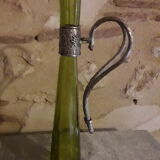 Large decanter with large glass neck and silver metal handle.
