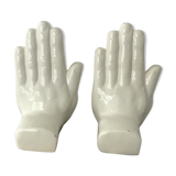 Hands tighten books in ceramics