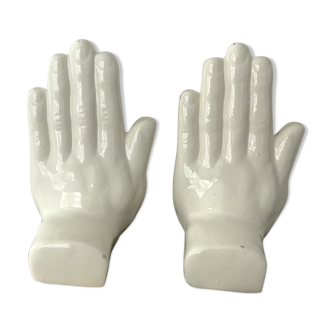 Hands tighten books in ceramics