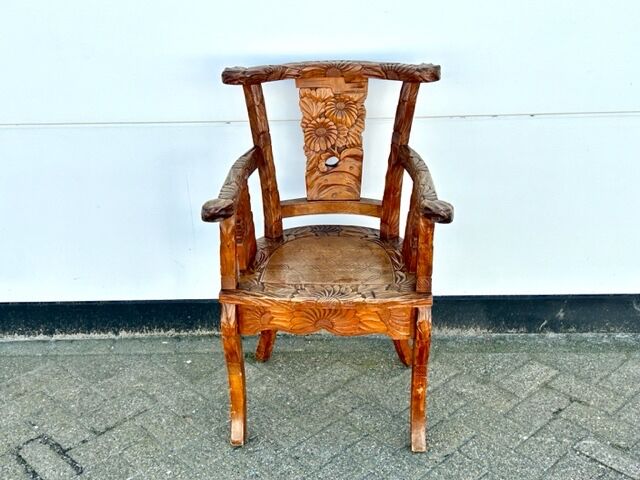 Hand stabbed teak armchair