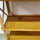 Vintage shelf on legs made of rattan and wood.